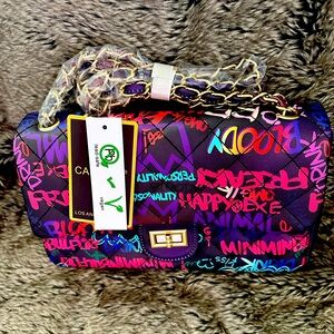 Caleesa graffiti purse with chain-link handle. stylish purse has compartments..